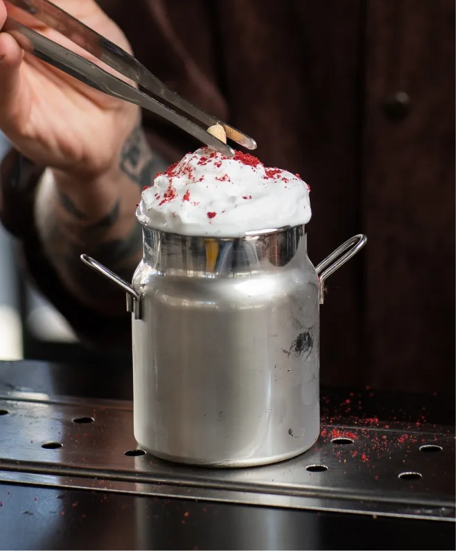 Chef mixing chocolate in a bowl while preparing dessert