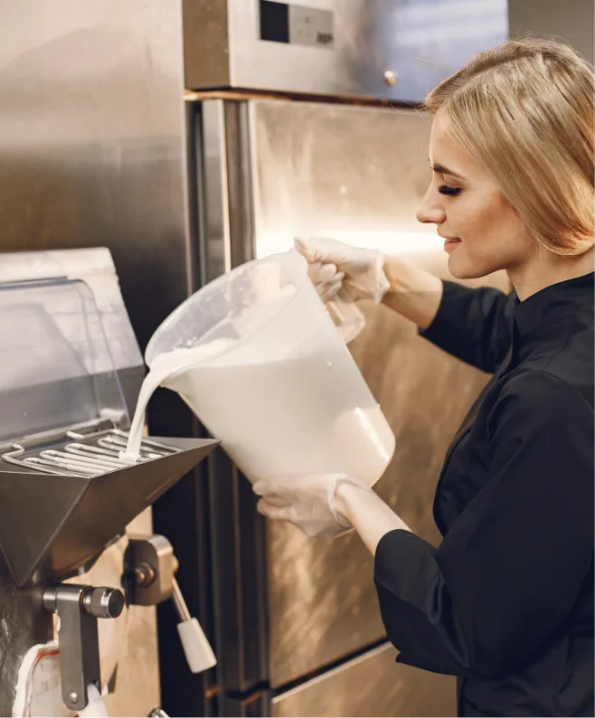 Chef adding topping to dessert in a professional kitchen